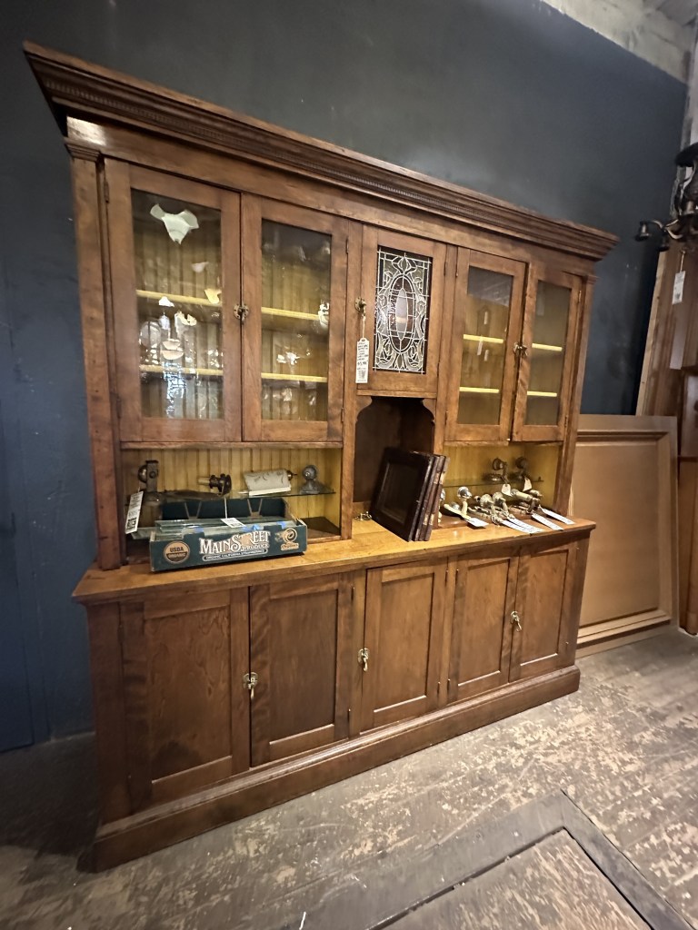 Antique built-in oak hutch with glass-front cabinets, found at an architectural salvage shop
