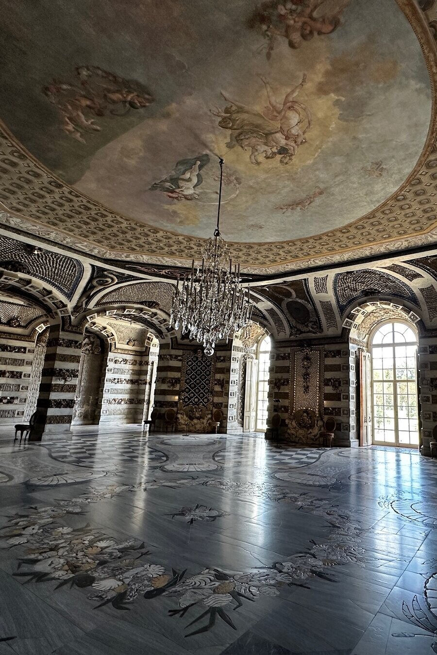 Marble Hall at Sanssouci with domed fresco ceiling, crystal chandelier, and inlaid marble floor, Potsdam Germany
